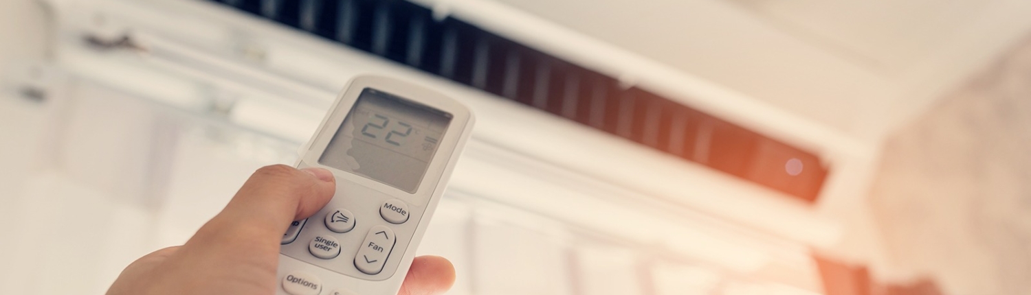 Air,Conditioner,Inside,The,Room,With,Woman,Operating,Remote,Controller.