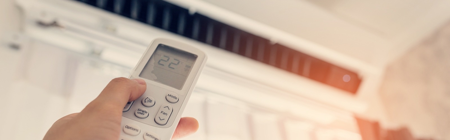 Air,Conditioner,Inside,The,Room,With,Woman,Operating,Remote,Controller.